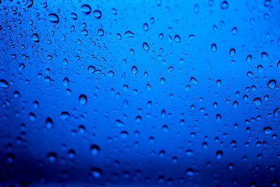 Full frame shot of raindrops on window