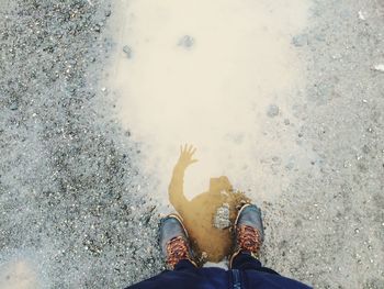 Low section of person standing on tiled floor