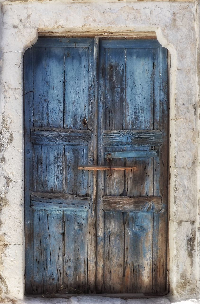 CLOSED DOOR OF OLD WOODEN HOUSE