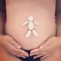 Baby made of pills on pregnant woman stomach