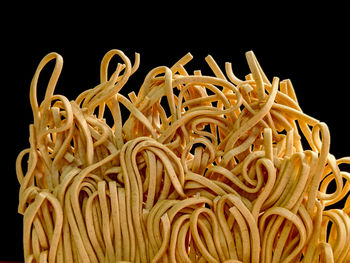 Close-up of noodles against black background