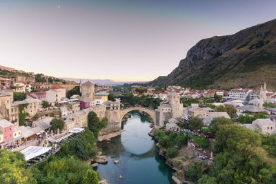 High angle view of town amidst river against sky