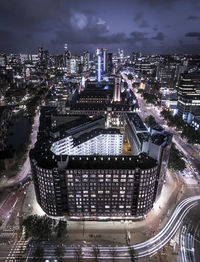 High angle view of illuminated buildings against sky at night