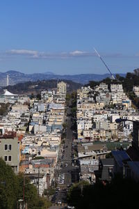 High angle view of residential district against blue sky