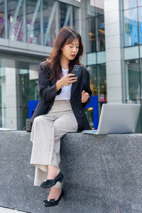 Young woman using phone