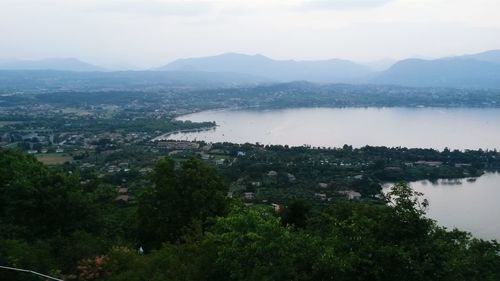 Scenic view of lake by mountains against sky