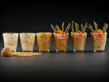 Close-up of served food on table against black background