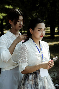 Portrait of a beautiful young woman holding camera