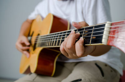 Close-up of man playing guitar