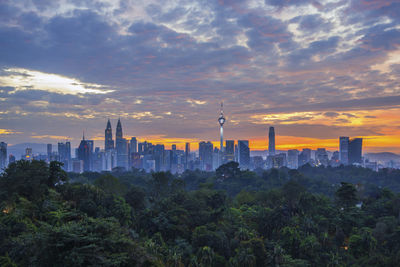 View of buildings against cloudy sky during sunset