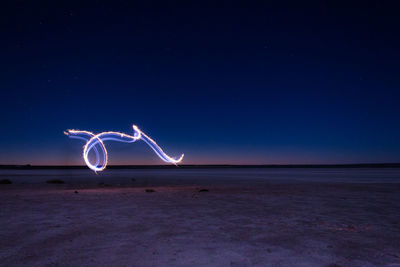 Light painting against blue sky at night