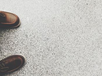 Directly above shot of shoes on road