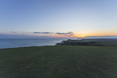 Scenic view of sea against clear sky during sunset