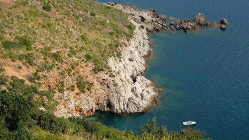 High angle view of rocks on sea shore