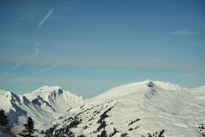 Scenic view of snow covered mountains against sky