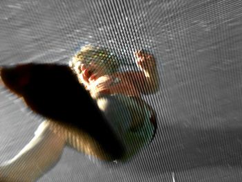 Low angle view of boy standing on metallic flooring