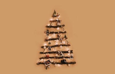 Directly above shot of christmas tree against orange background