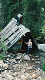 Woman standing on rock in forest