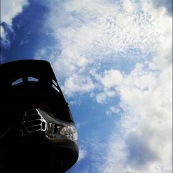 Low angle view of building against cloudy sky