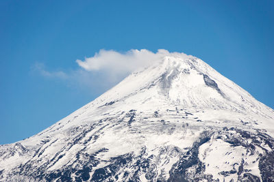 Low angle view of snowcapped mountain against sky