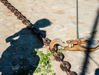 High angle view of chain attached on wall