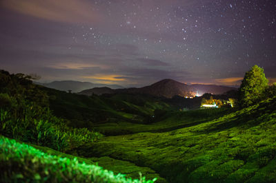 Scenic view of landscape against sky at night