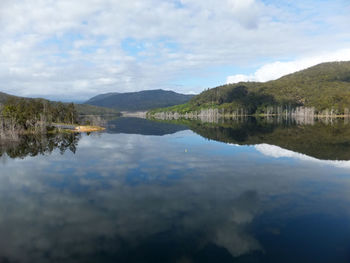 Scenic view of lake and mountains against sky