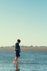 Portrait of little boy walking on the beach