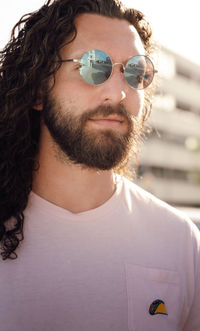 Portrait of young man wearing sunglasses on the streets 