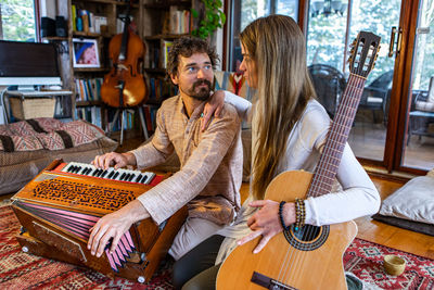 Young couple sitting at home