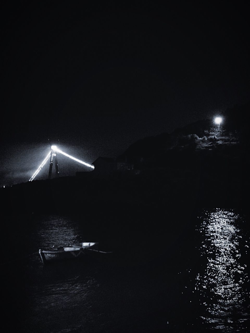 night, water, illuminated, waterfront, built structure, copy space, architecture, clear sky, river, connection, transportation, sea, bridge - man made structure, reflection, nautical vessel, sky, building exterior, outdoors, dark, tranquility