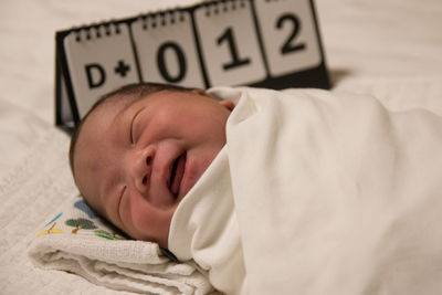 Baby boy sleeping on bed