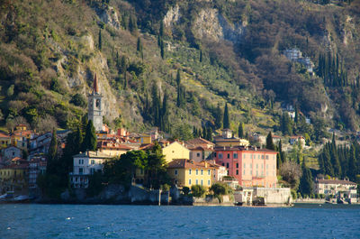 Scenic view of sea by town against sky