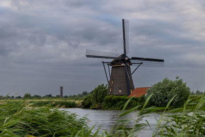 Beautiful wooden windmills at sunset in the dutch village of kinderdijk. windmills run on the wind.