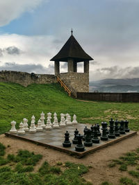 Chess on field against sky