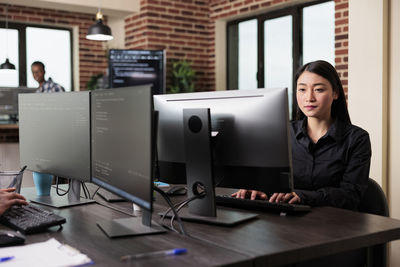 Portrait of businesswoman working at table