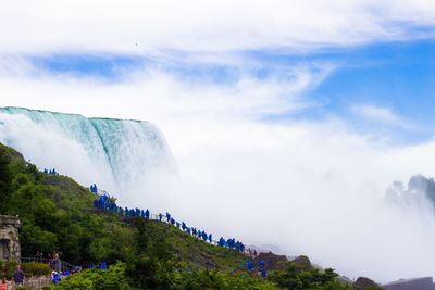 Scenic view of waterfall against sky