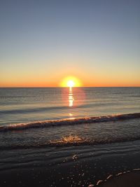 Scenic view of sea against clear sky during sunset