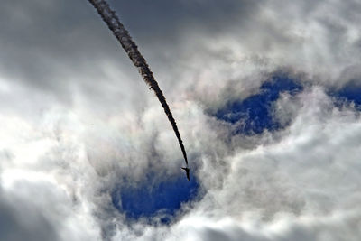 Low angle view of vapor trails against sky