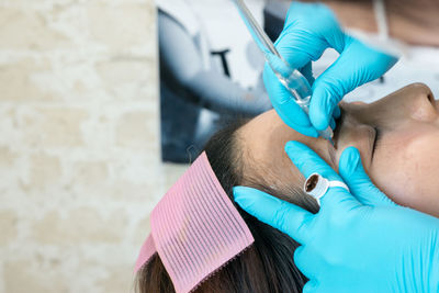 Close-up of woman  getting eyebrow tattoo