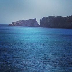 Scenic view of sea against blue sky