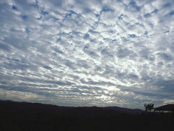 Silhouette landscape against sky during sunset