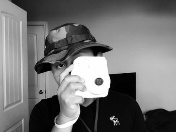 Close-up of woman holding camera