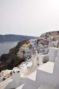 Townscape by sea against clear sky