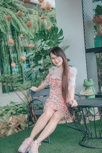 Portrait of smiling young woman sitting on chair