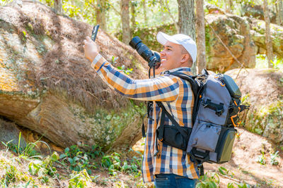 Rear view of man standing on rock