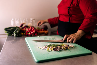 Midsection of woman preparing food at kitchen