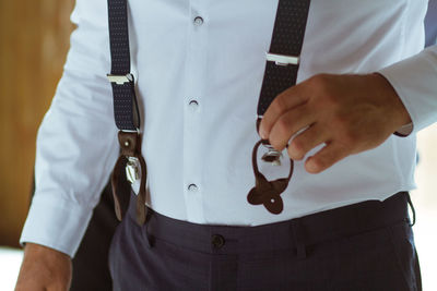 Midsection of suspenders in formalwear