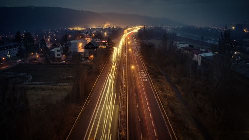 High angle view of light trails on road at night