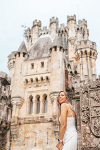 Low angle view of woman against historic building